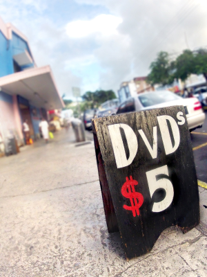 vendor street sign with dvd's on sale